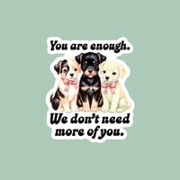 Sticker with three puppies and text on a checkered background