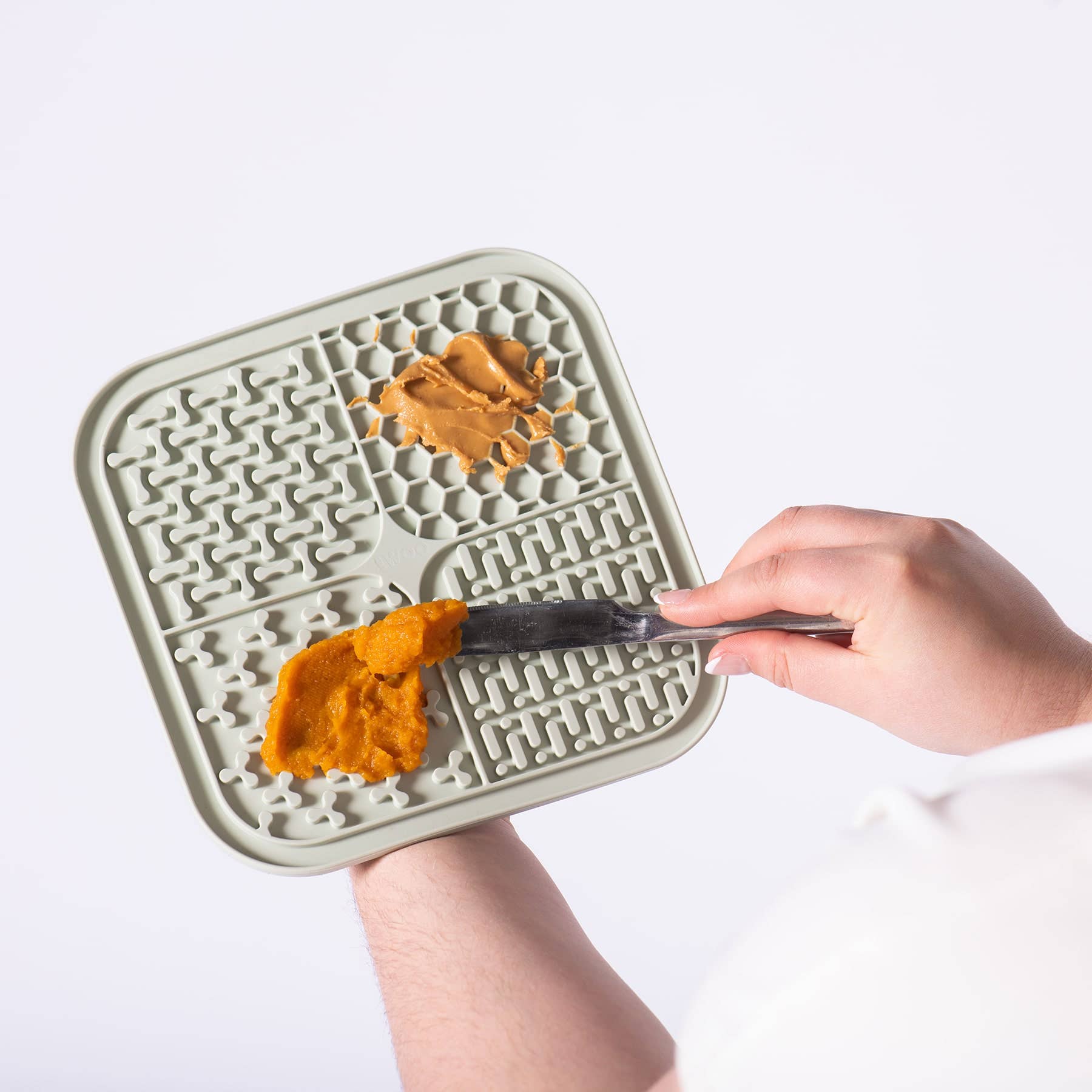 Awoo SMOOSH Lick Mat showing four distinct textured zones designed for spreading treats and enrichment activities.