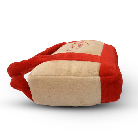 Chomp Haus Traderr Woof's Tote Toy showing detailed construction and fabric texture of the dog carrying toy.