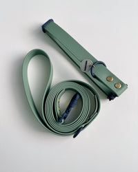 Hund & Shore Clover waterproof collar showing detailed view of green webbing and metal hardware construction.