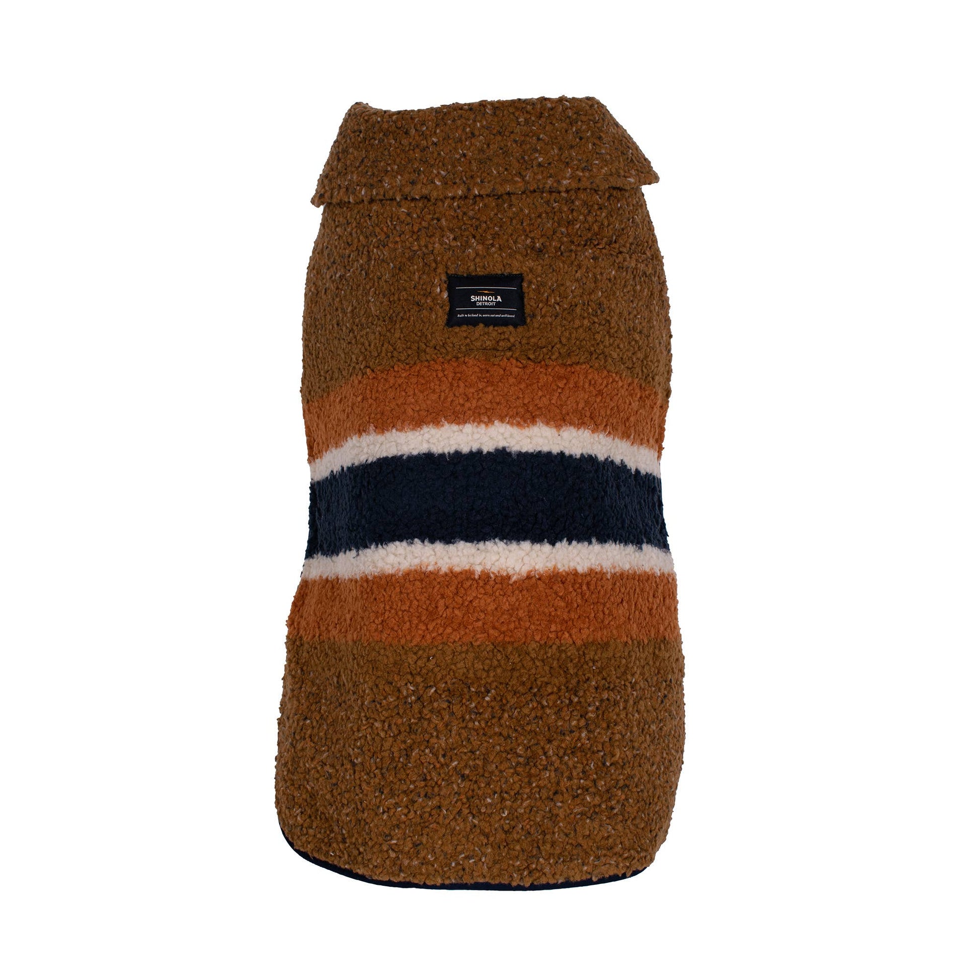 Shinola Pet brown barn-style dog coat showing adjustable straps and reversible shearling lining detail.
