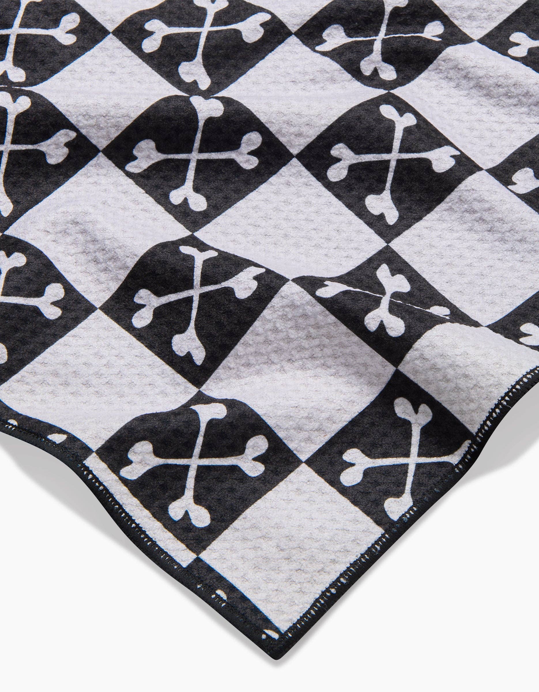 Close-up detail of Geometry Boneyard Black Checkerboard Dog Towel showing the distinctive checkered pattern and fabric texture.