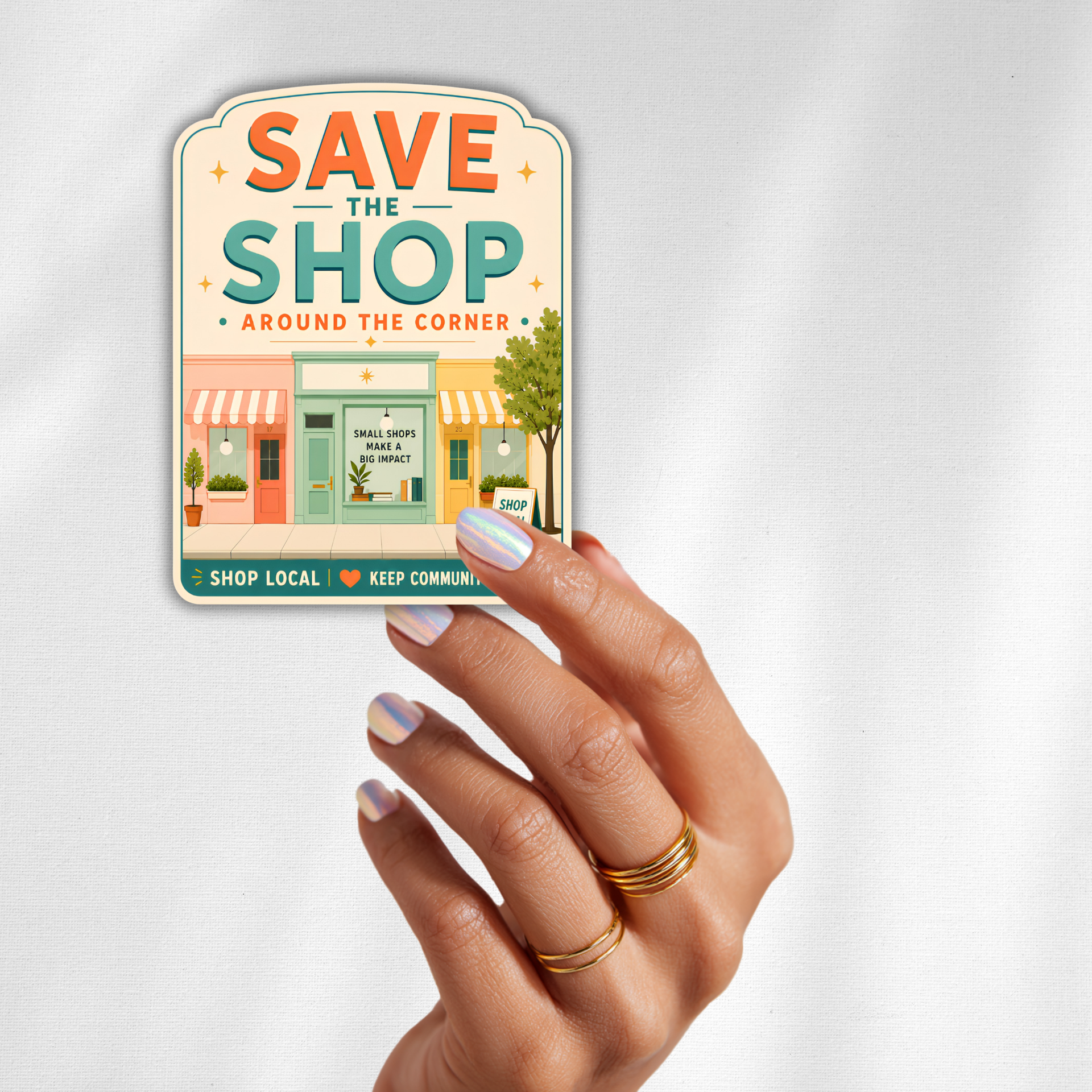 Close-up detail of the inviting affairs paperie Save the Shop Around the Corner shop local sticker design.