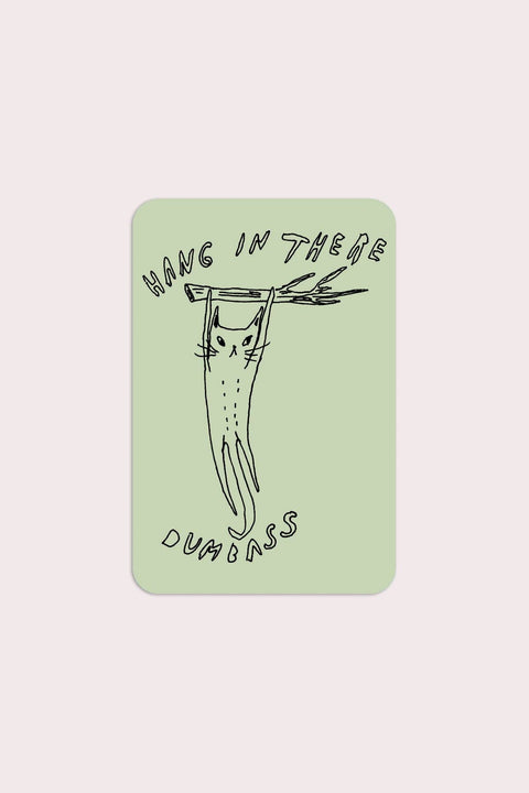 Close-up detail of Stay Home Club Hang in There sticker showing rounded rectangular shape and humorous motivational design.