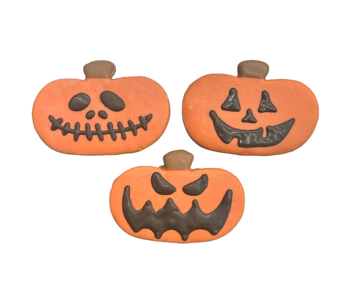 Paws Gourmet Bakery Jack-O-Lantern dog treat with orange frosting and carved pumpkin face design.