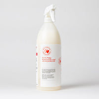 Skout's Honor Stop Marking spray bottle shown in use on a household surface to deter pet marking.