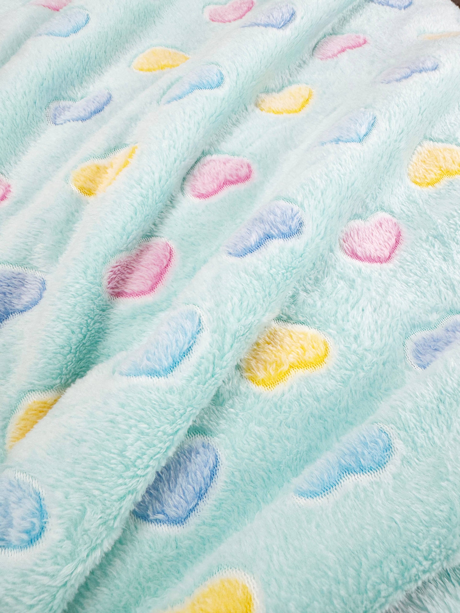 Klippo Pet Blue Hearts Blanket shown in lifestyle setting demonstrating size and plush texture for dogs.