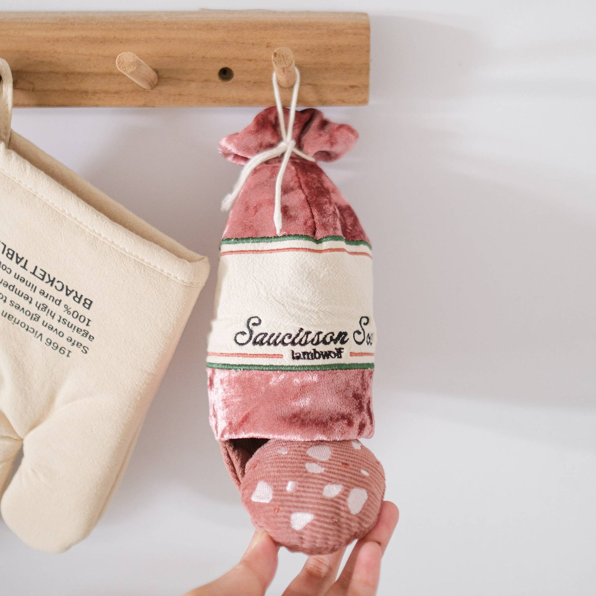 Lambwolf Collective SAUCISSON enrichment toy showing crinkly textured exterior casing and hidden compartments for treats.