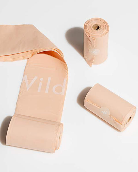 Wild One eco-friendly poop bags packaging showing six rolls of cornstarch-based waste bags for dogs.