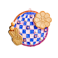 A dog licking treats from the blue Barks and Brownies Sea Licking Mat on a kitchen floor.