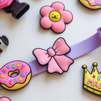 Ribbon Pink Jiby Dog Charm by Jiby Dog Crew shown styled on a dog collar or accessory.
