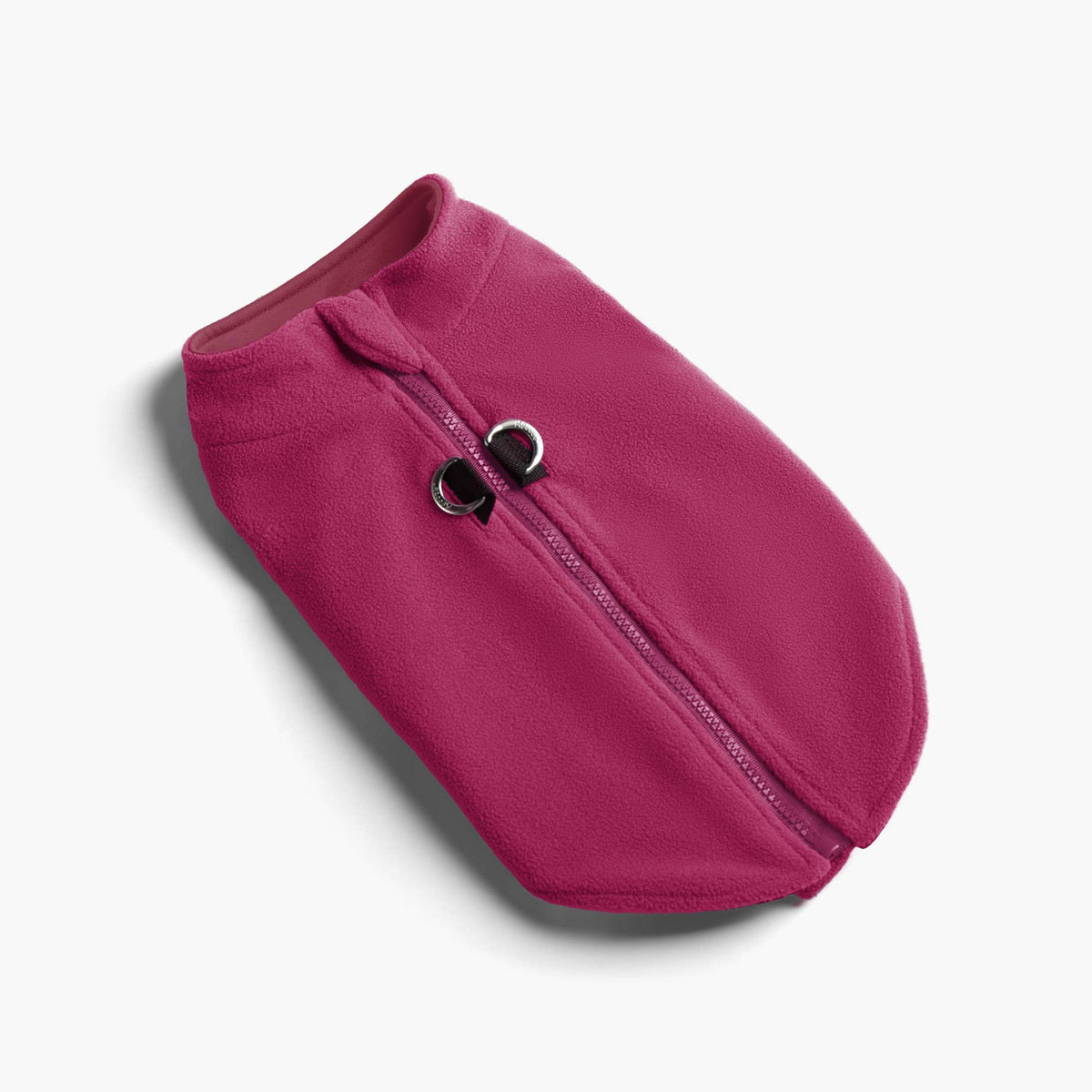 Small dog wearing the Gooby Zip Up Fleece Vest in a cozy lifestyle setting.