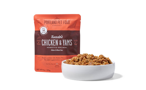 Portland Pet Food Company Tuxedo's Chicken and Yams dog meal can showing ingredient details or nutrition label.