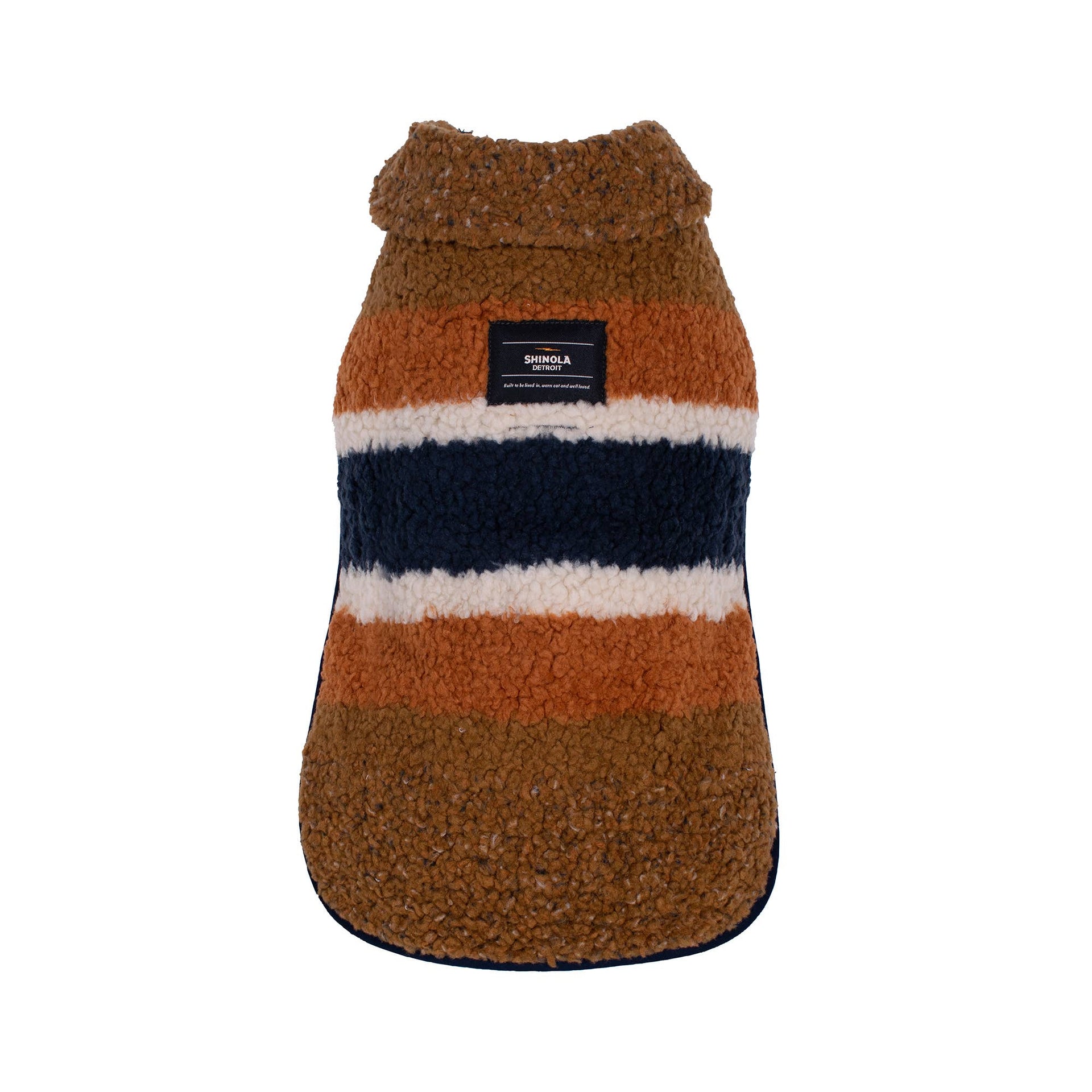 Shinola Pet brown barn-style dog coat shown from side angle displaying adjustable straps and reversible design details.