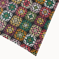 Camp Hound Willow Dog Bandana showing detailed view of colorful granny square crochet pattern on cotton fabric.