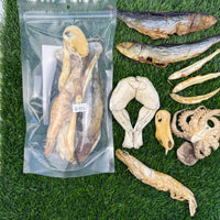 Golden Nibbles Neptune's Nibbles seafood variety bag showing freeze-dried fish treats through clear packaging window.