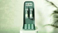 Earth Rated single poop bag roll showing detailed view of perforated bags and compact green packaging design.