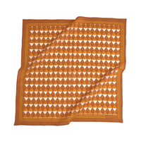 Orange and white patterned fabric on a white background