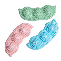 SnugArooz Pea Podz green interactive dog toy showing removable pea squeakers partially emerging from fabric pod.