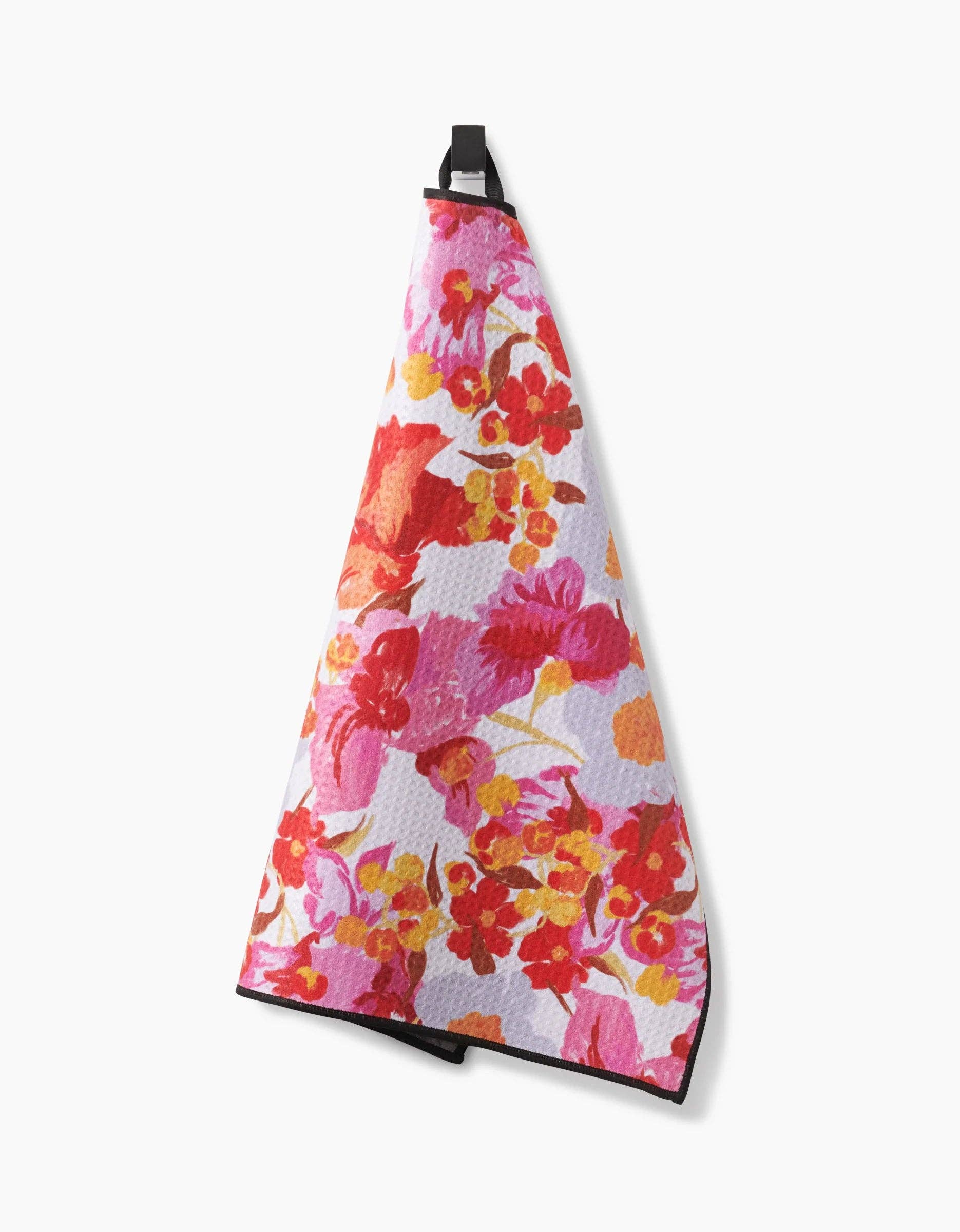 Geometry Pup Florals Paw Towel being used to clean a dog's muddy paws after outdoor play.