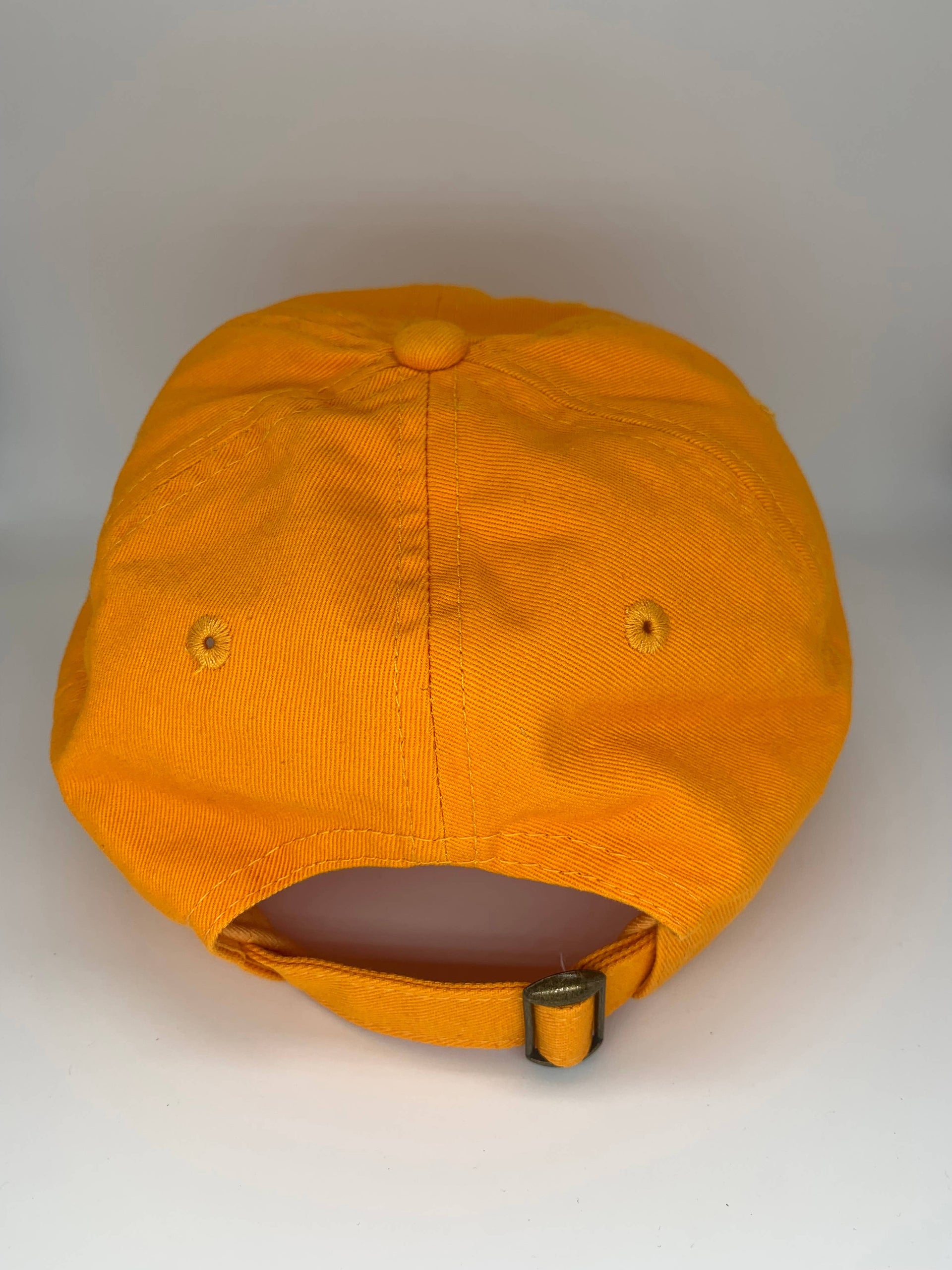 BARK JAX orange cotton hat with cream embroidered Dog Vibes Only text worn in casual lifestyle setting
