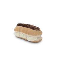 Lambwolf Collective Eclair enrichment dog toy with textured cream-colored flaps and treat-dispensing pockets for mental stimulation.