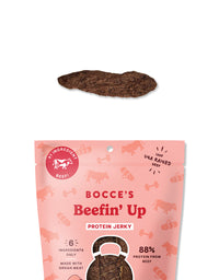 Bocce's Bakery Beef Jerky Cuts dog treats shown in a lifestyle setting with a happy dog nearby.