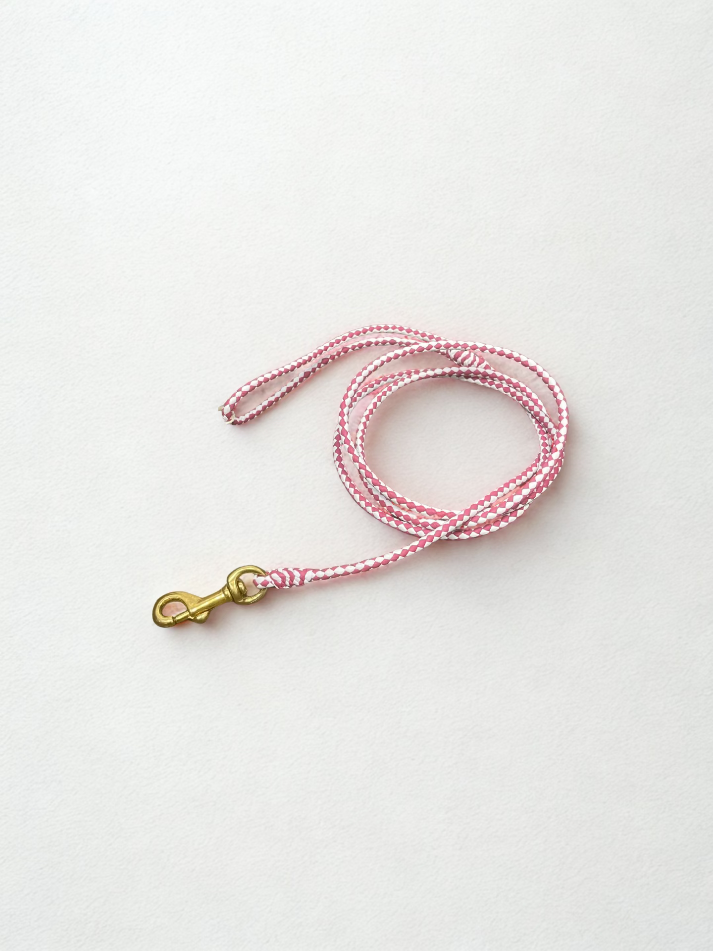 Alvalley braided leather snap lead being held to show detailed craftsmanship and rich brown leather texture.