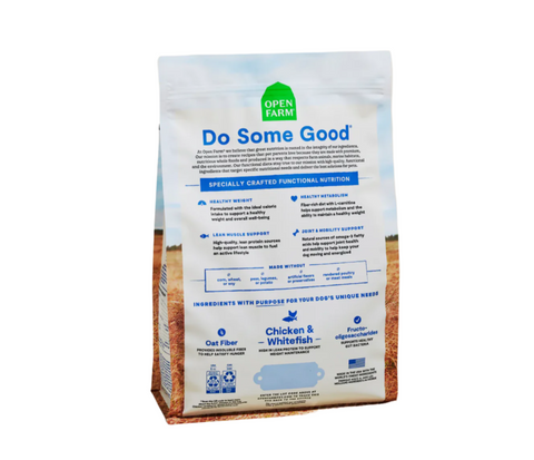 Open Farm Healthy Weight dog food kibble scattered on white surface showing texture and brown color.