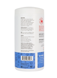 Skout's Honor Grooming Wipes shown in use gently cleaning a dog's paw or coat.