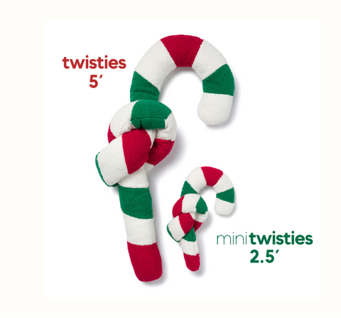A dog playing with the fabdog Twisty Candy Cane toy, showing its flexible twistable design in action.