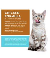 Weruva Phos Focused chicken treat tube being offered to a cat showing the lickable texture and feeding method.