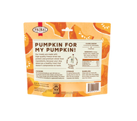 Primal freeze-dried chicken and pumpkin dog treats scattered on wooden surface showing texture and size.