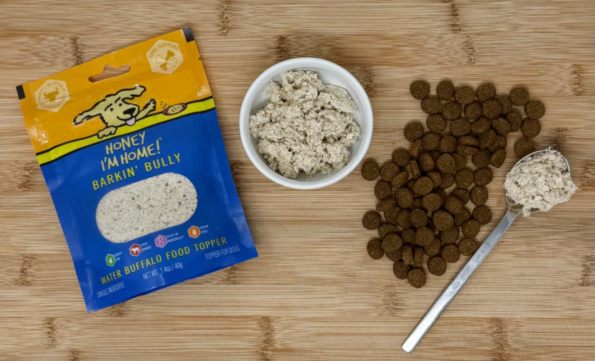 Honey I'm Home Barkin' Bully Food Topper sprinkled over dog kibble in feeding bowl demonstration.