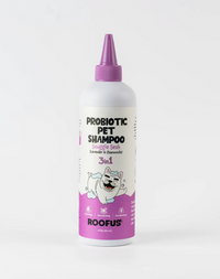 Roofus Snuggle Sesh dog shampoo bottle with purple label and pump dispenser against white background
