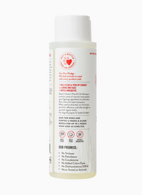 Skout's Honor Flea & Tick Shampoo shown in a real-world grooming setting with a dog being bathed.