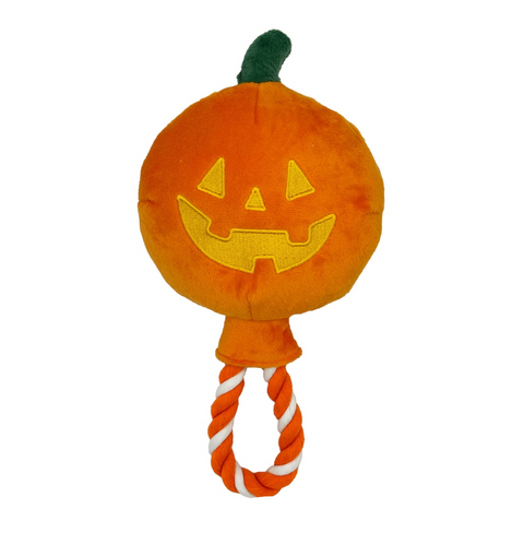 Plush pumpkin toy with a rope handle on a white background