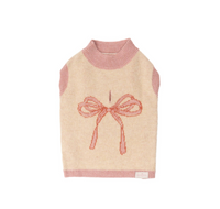 Beige sweater with pink trim and bow design on a white background