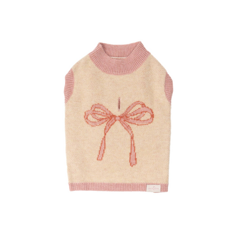 Beige sweater with pink trim and bow design on a white background