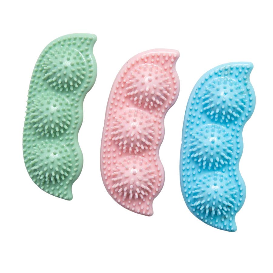 SnugArooz Pea Podz green interactive dog toy showing removable pea squeakers and plush pod design detail.
