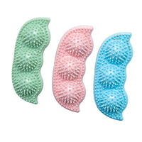 SnugArooz Pea Podz green interactive dog toy showing removable pea squeakers and plush pod design detail.
