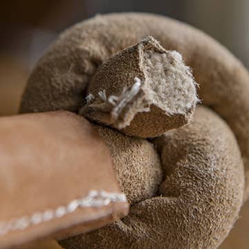HuggleGroup Huggle-Hide Natural Leather Knotted Bone dog chew toy showing detailed texture and knot construction.