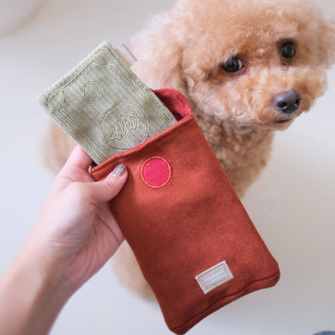 Lambwolf Collective RED POCKET enrichment toy featuring red fabric with golden accents and treat-hiding compartments for dogs.