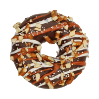Dog Dish K9 Granola Factory carob-covered dog donut topped with crunchy pretzel pieces and white icing drizzle.