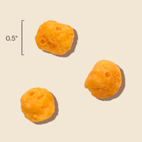 Dog Dish Honest Kitchen cheddar cheese dog treat bites, showing size scale for training snacks.