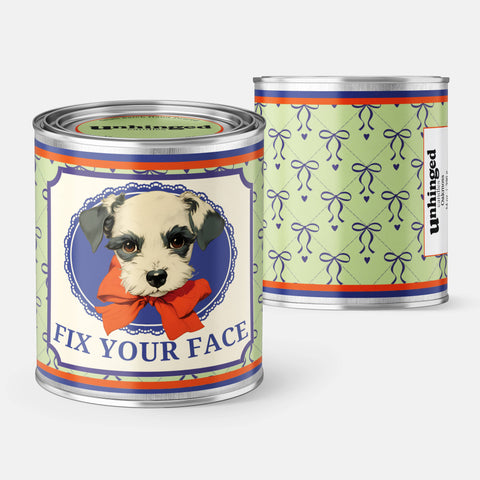 Close-up detail of the Unhinged Candles Fix Your Face Dog soy candle label and texture.