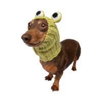 Dog Dish Frog Dog Snood worn by a dachshund, featuring a lime green knit design with cute frog eyes.