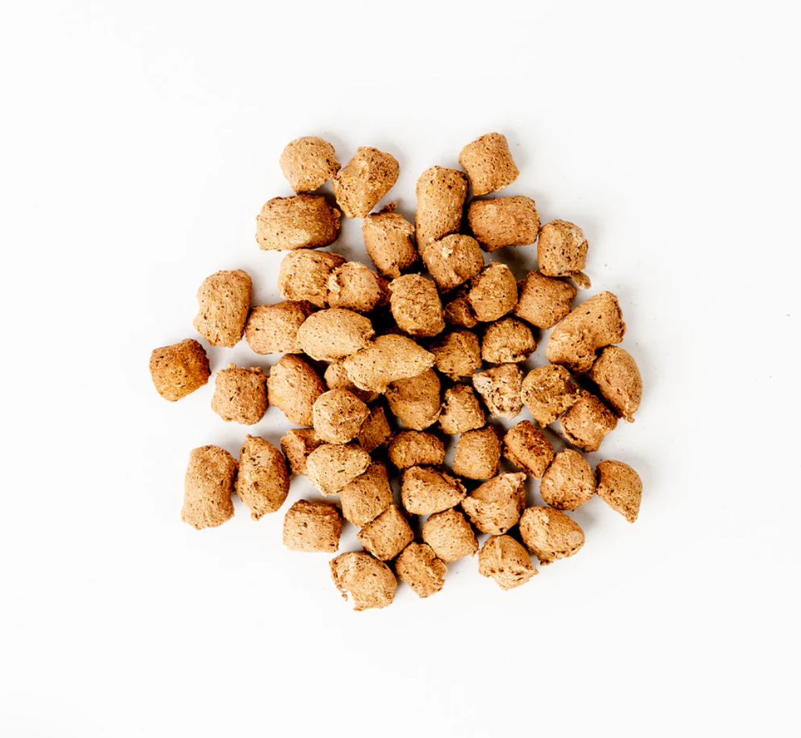 Dog Dish Green Juju Beef Red Bites, freeze-dried grass-fed beef organ treats for dogs and cats on a white background.