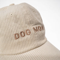 Dog Dish ivory corduroy baseball cap with Dog Mom embroidered in brown thread, featuring a soft textured finish.