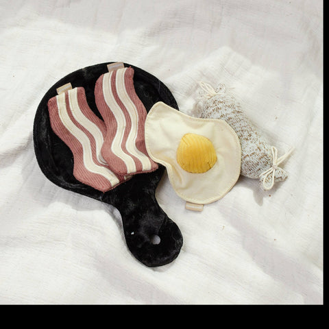 Dog Dish Lambwolf breakfast enrichment snuffle toy set with a black frying pan, bacon, egg, and sausage dog toys.